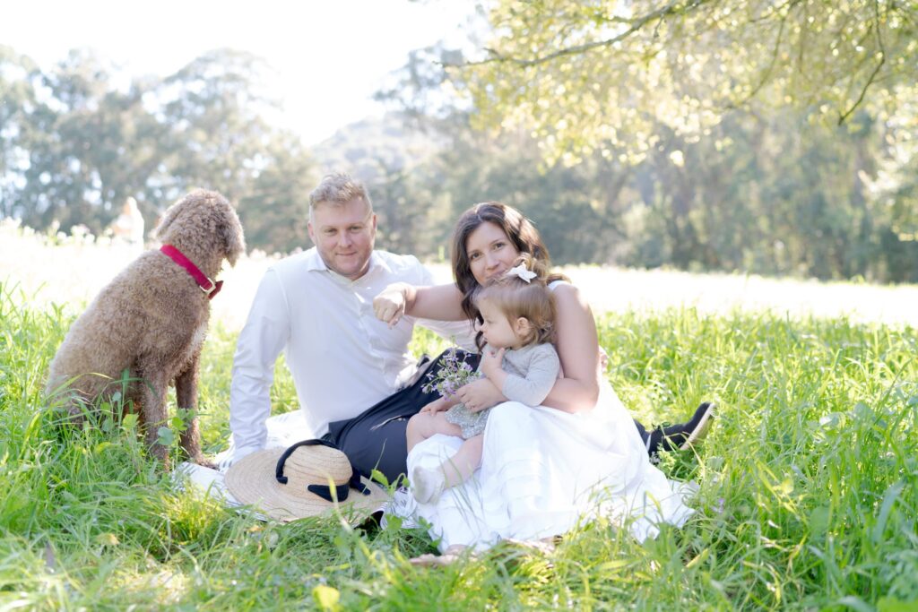 Jilian, Amos, their daughter, and their pet dog.