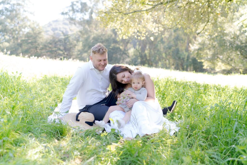 Loving husband and wife look passionately at their baby daughter.