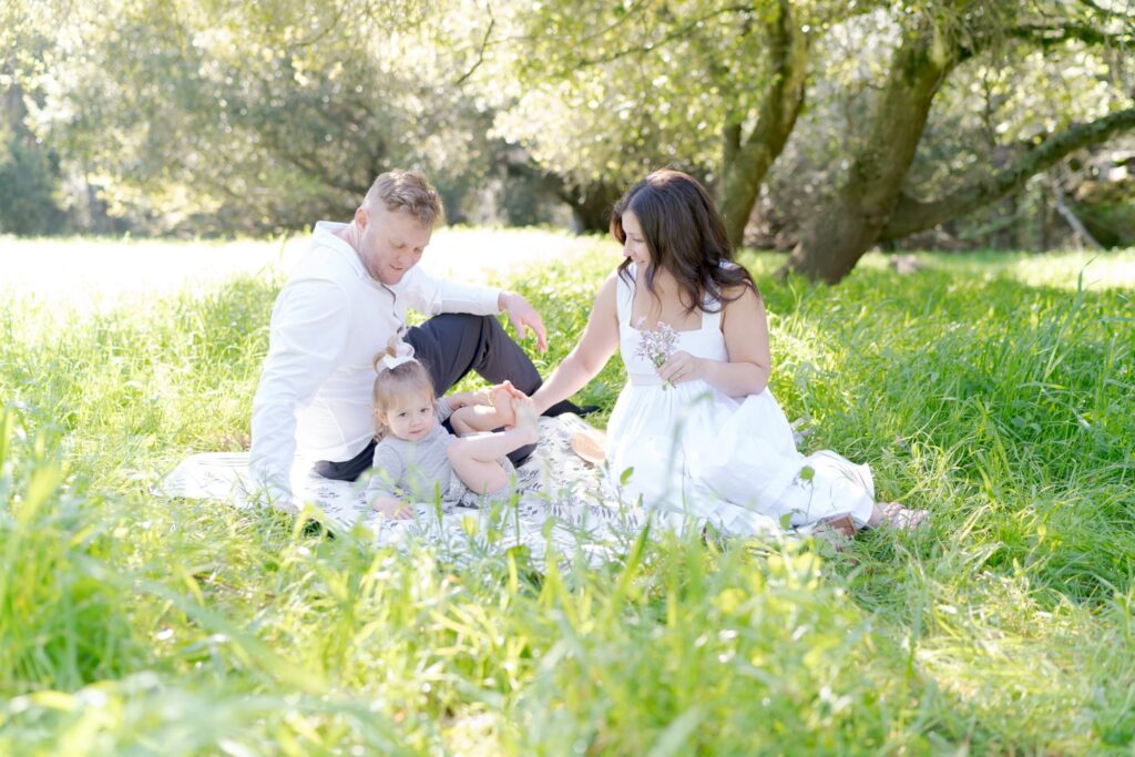 Oakland family picnic amidst tall grasses.