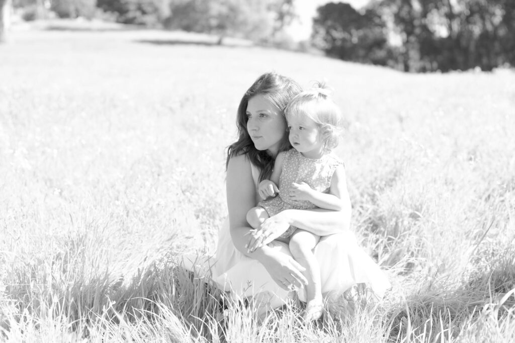 Woman and her baby daughter look out into the wild.