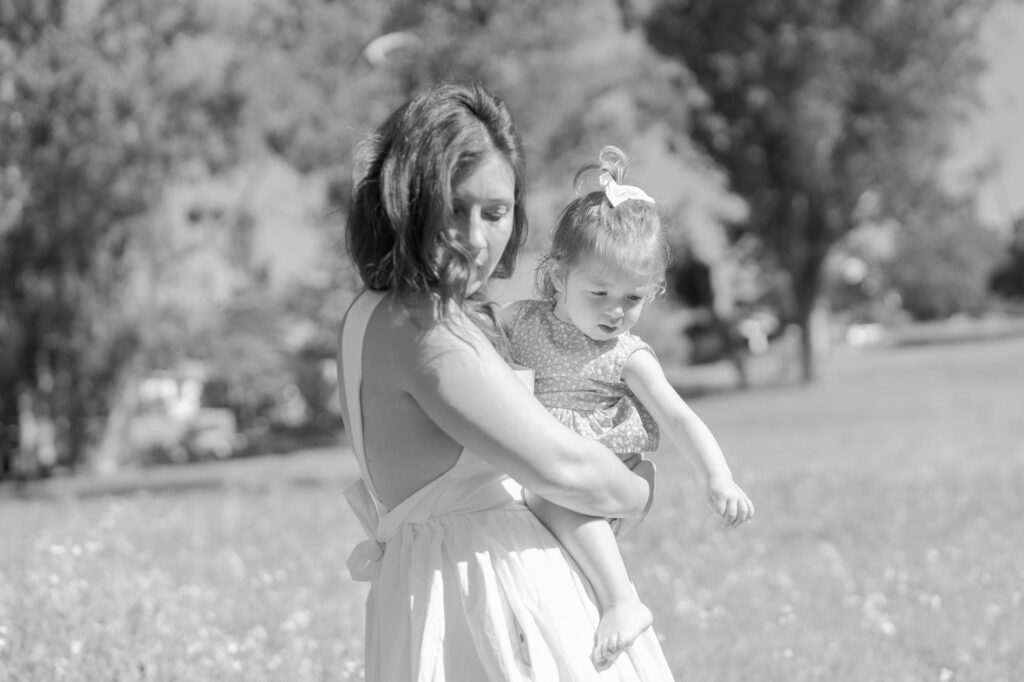 Mom holds her daughter in her arms.