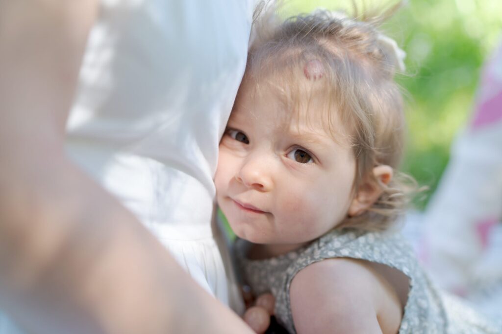 Cute baby daughter leans into her mom/