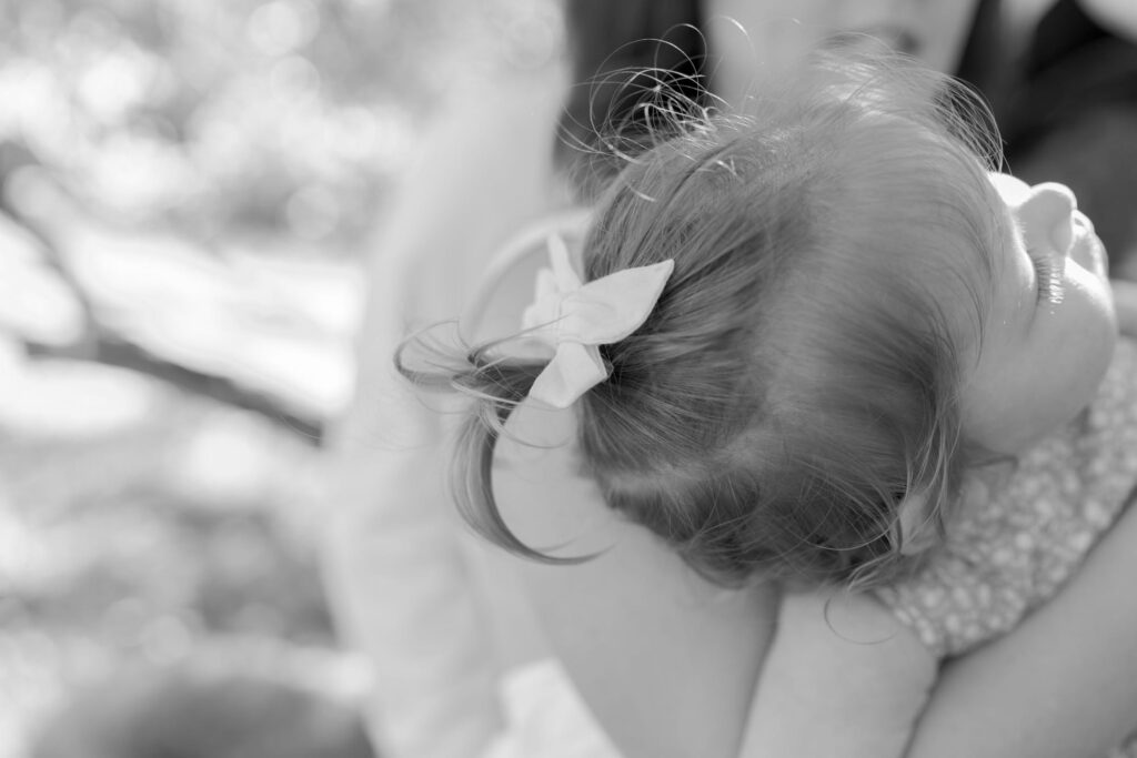 Baby daughter with her hair tied with a cute ribbon.