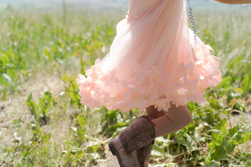 Little girl pink outfit and brown boots.