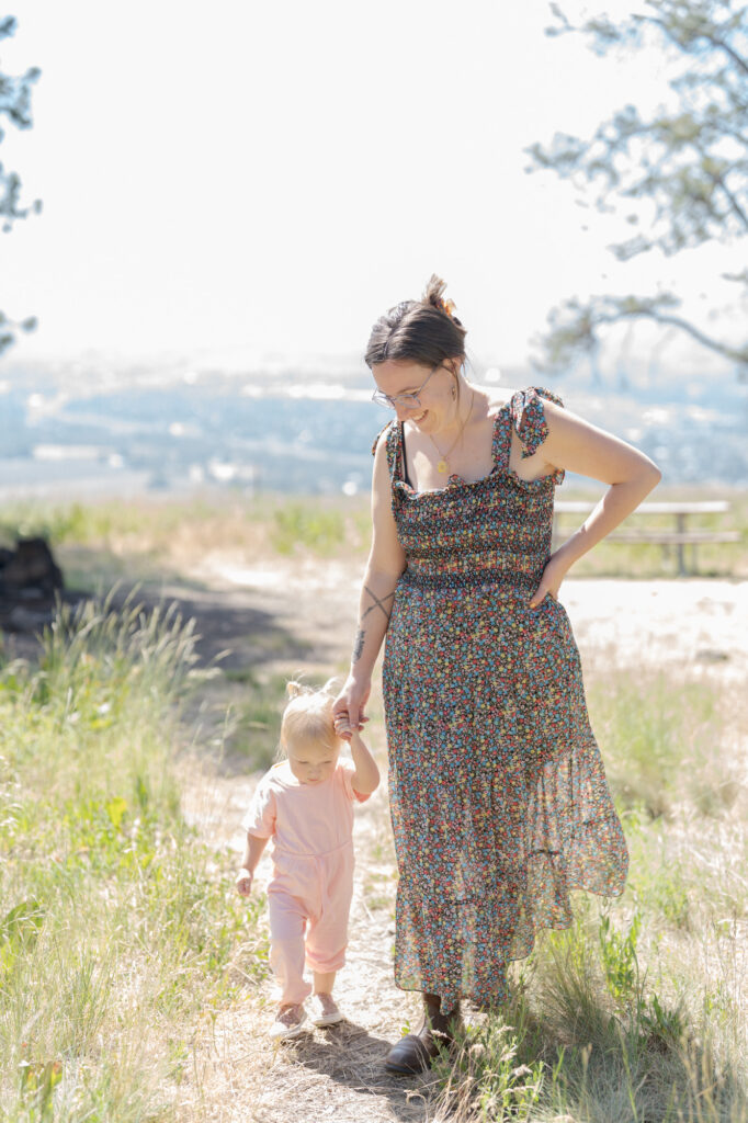 Mom holds her baby's hand and guides her into the wild.