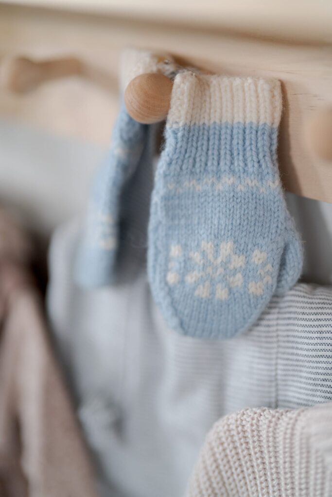 Tiny cute woolen gloves for the newborn baby.