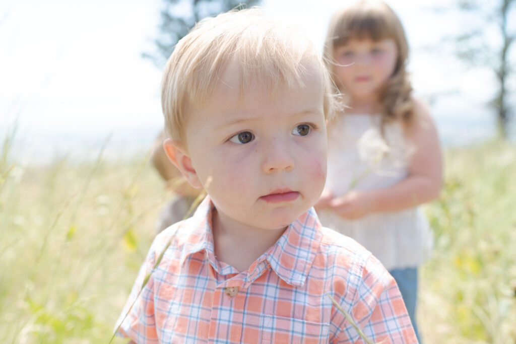 Sweet baby boy in a checkered orange shirt.