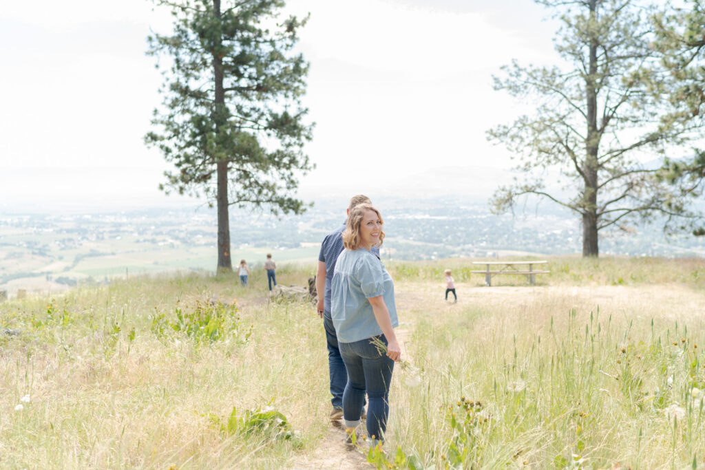 Lady looks into Robin Jolin's camera while her children play in the distant background.