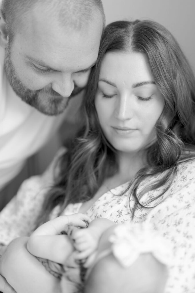 Mom and dad hold their newborn baby.