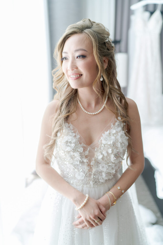 Bride in a flowery-design wedding gown.