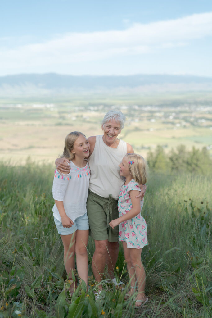 Grandma embraces her two cute granddaughters.