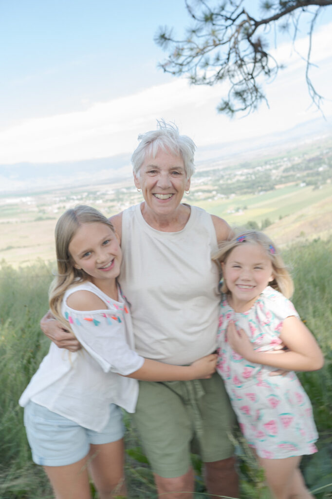 Professional Family Photographer Robin Jolin captures an elderly woman with her granddaughter giggling in-motion.