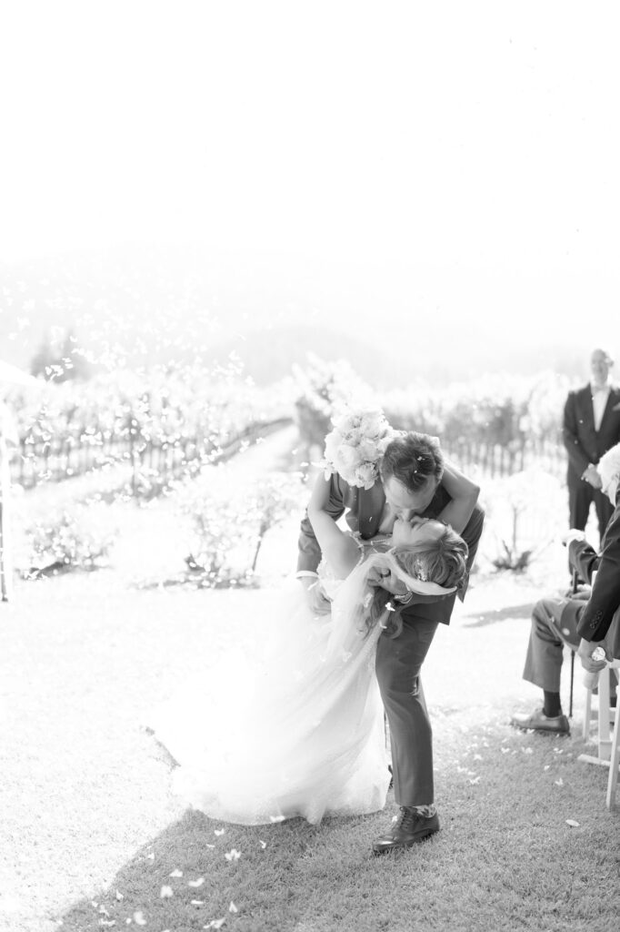 Groom kisses his bride at the aisle after being pronounced husband and wife.