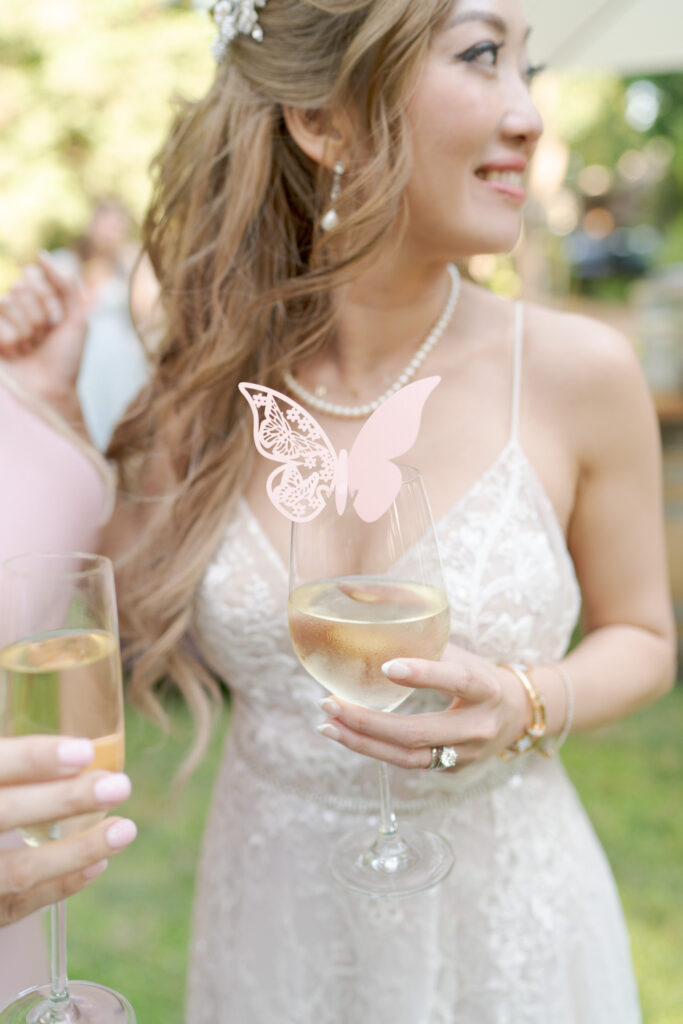 Pretty bride grabs a drink at the cocktail hour.