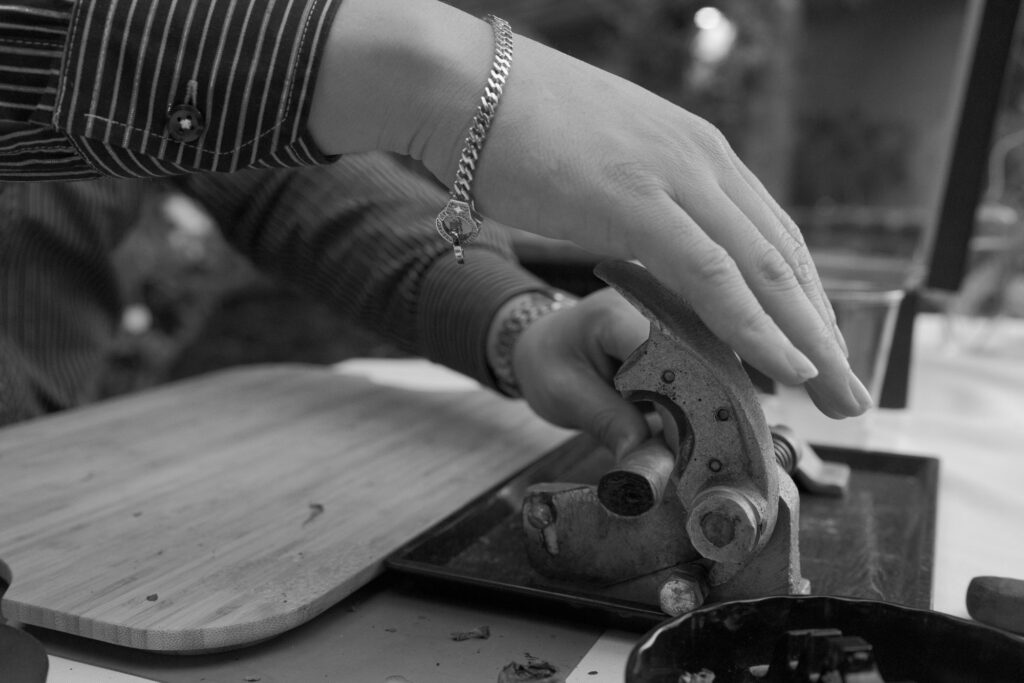 Man using a vintage cigar cutter.