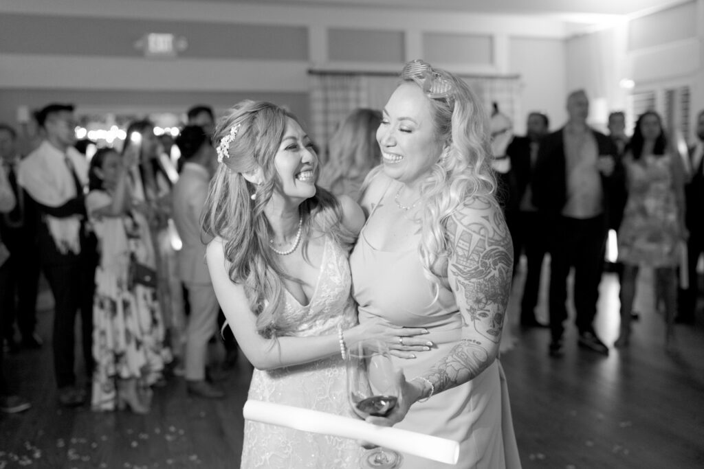 Bride and her bridesmaid dance at the wedding reception party.