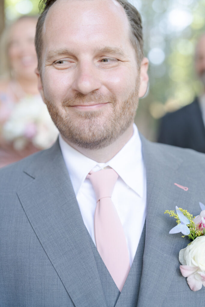 Bride with a boutonniere on his lapel.