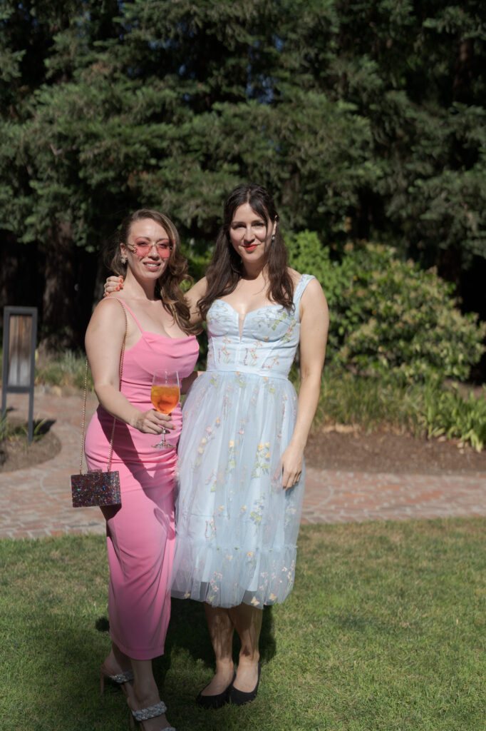 Two beautifully dressed female guests at the wedding reception.