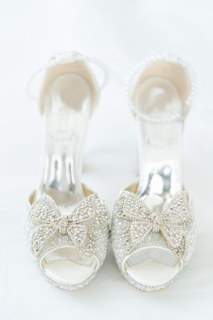 Pretty butterfly design white wedding sandals.