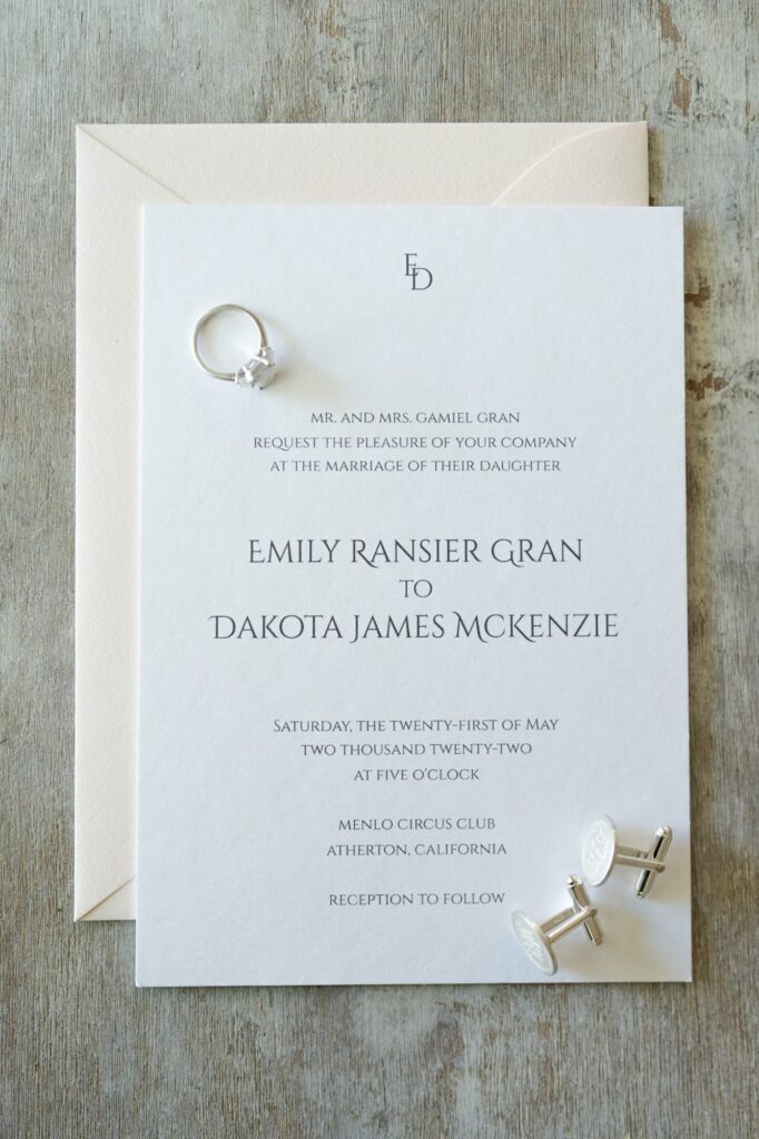 Elegant wedding card of Emily Ransier Gran and Dakota James Mckenzie.