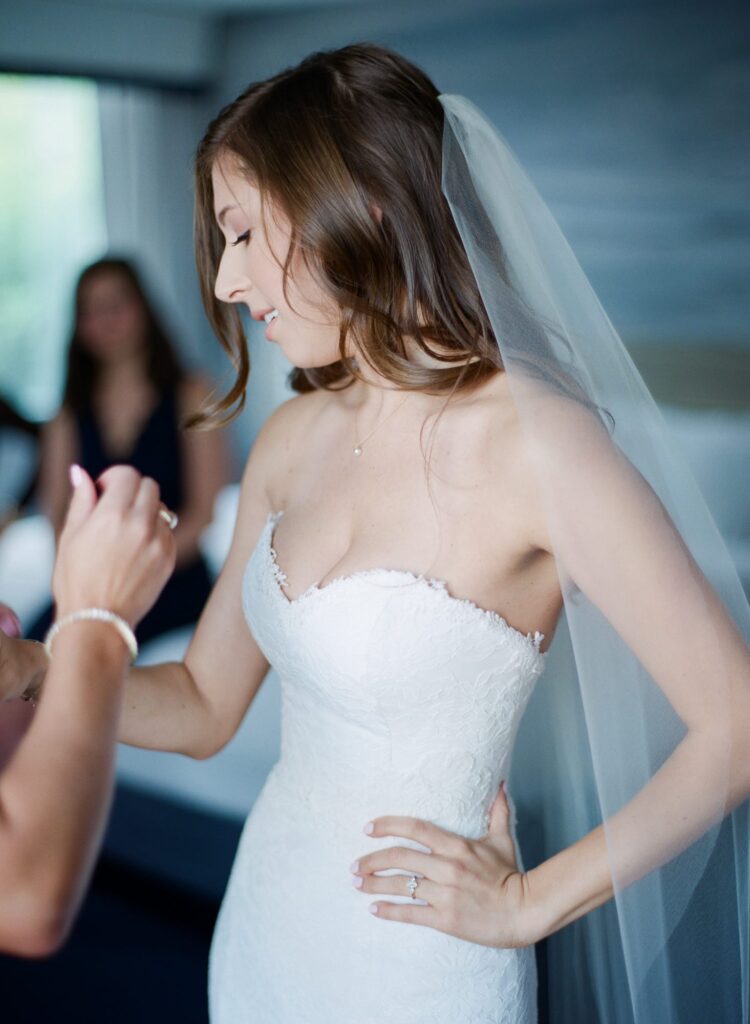 Bridesmaids help the bride-to-be prepare for her wedding.