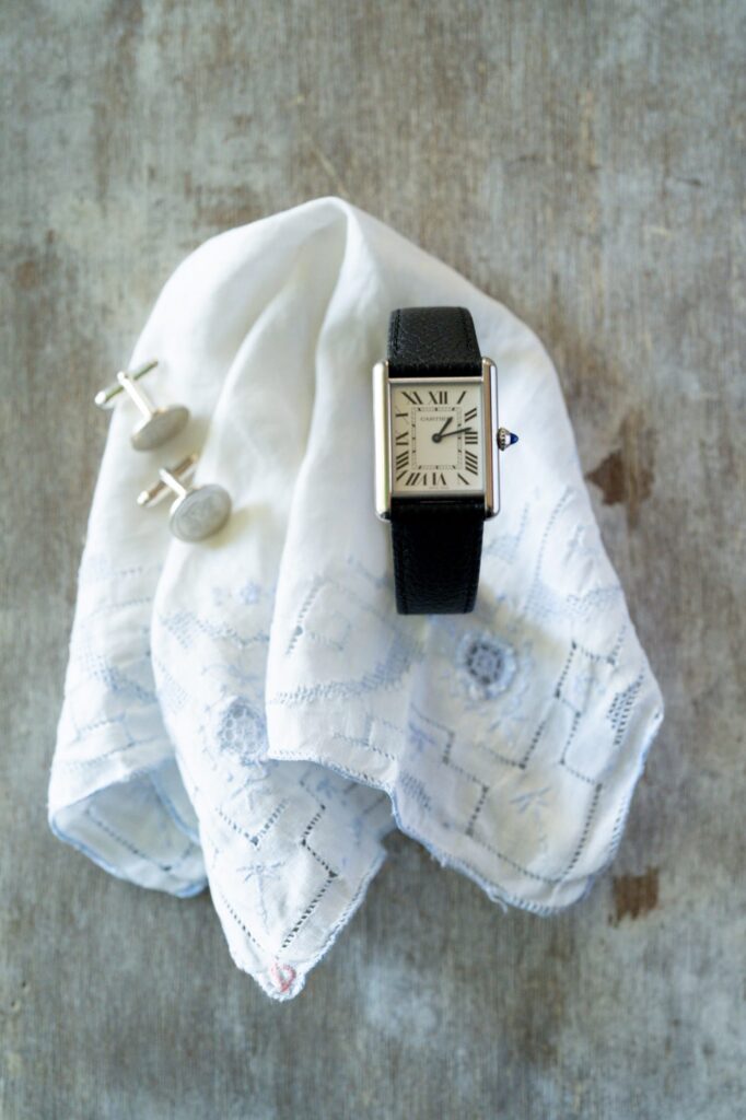 Cuffs, handkerchief and a classic black hand watch.