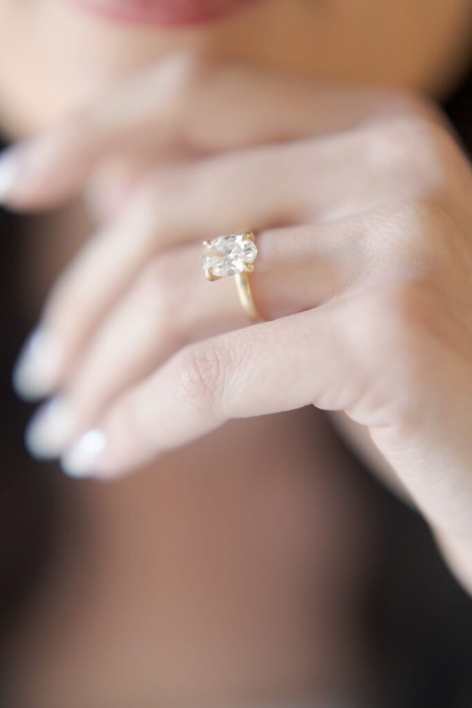 Beautiful wedding ring made of gold and diamond head worn on a lady's finger.