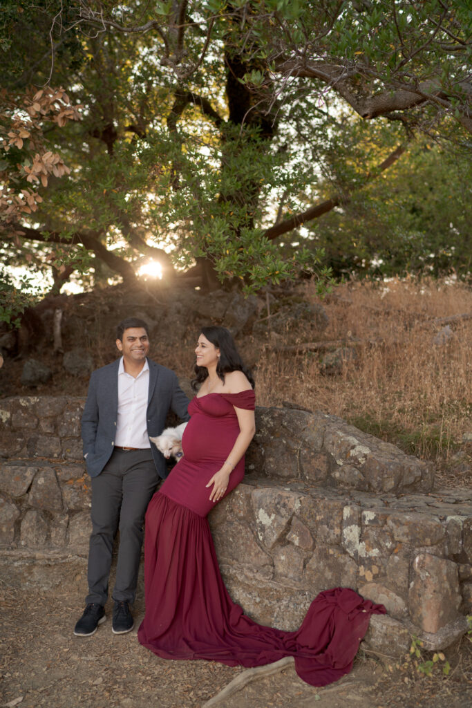 Husband holds his pregnant wife.