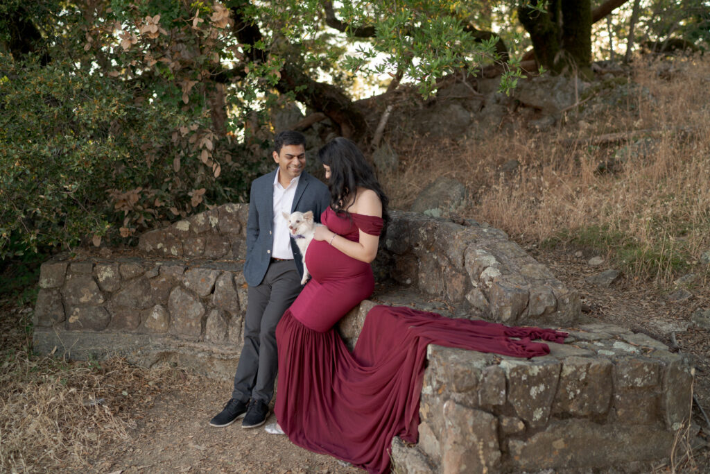 Husband and pregnant wife photoshoot with their pet dog.