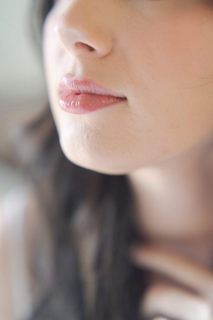 Aesthetic pink lips of a young lady.