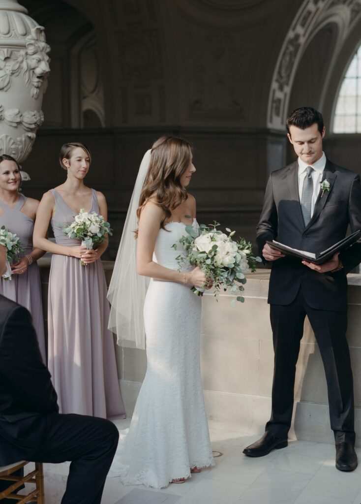 Wedding officiator makes the bride read her wedding vows.