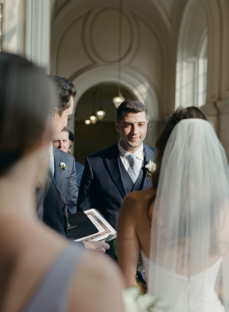 Groom looks at his wife-to-be during the wedding officiation ceremony.