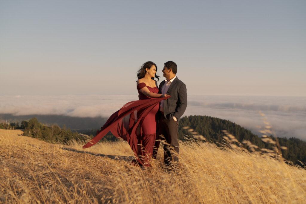 Husband and pregnant wife smile and look lovingly at each other.