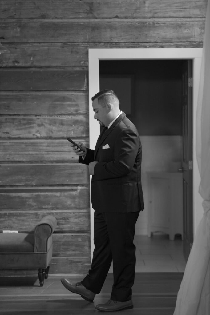 Bridegroom-to-be checks his phone moments before the wedding ceremony.