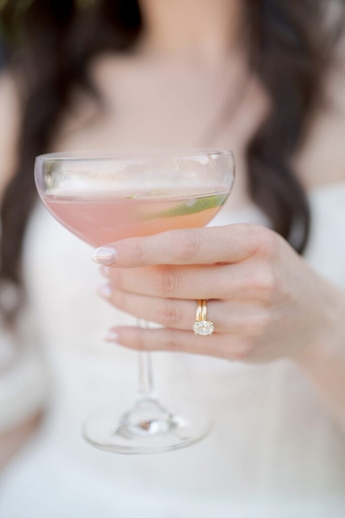 Pretty hand with a wedding ring grabs a glass of refreshment.