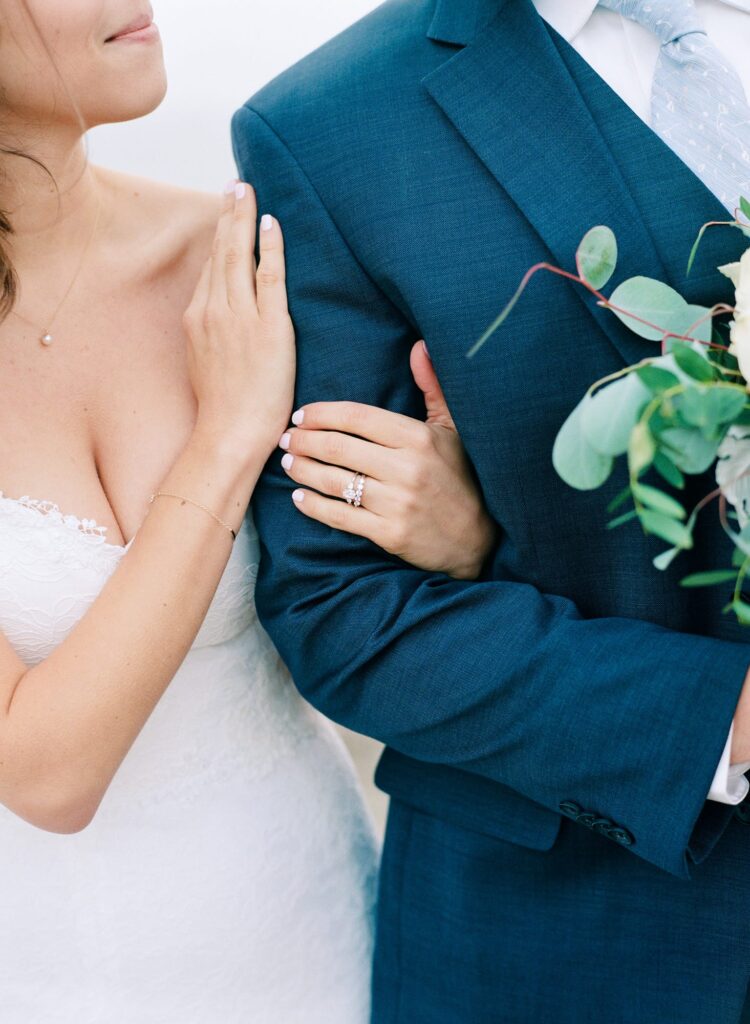 Newly married girl holds her husband's arm.