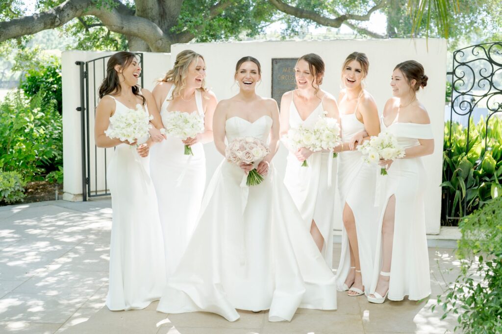 Beautiful bride accompanied by her stunningly dressed bridesmaids.