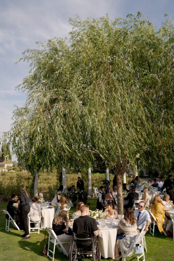 Guests seated at tables at a wedding reception party venue.