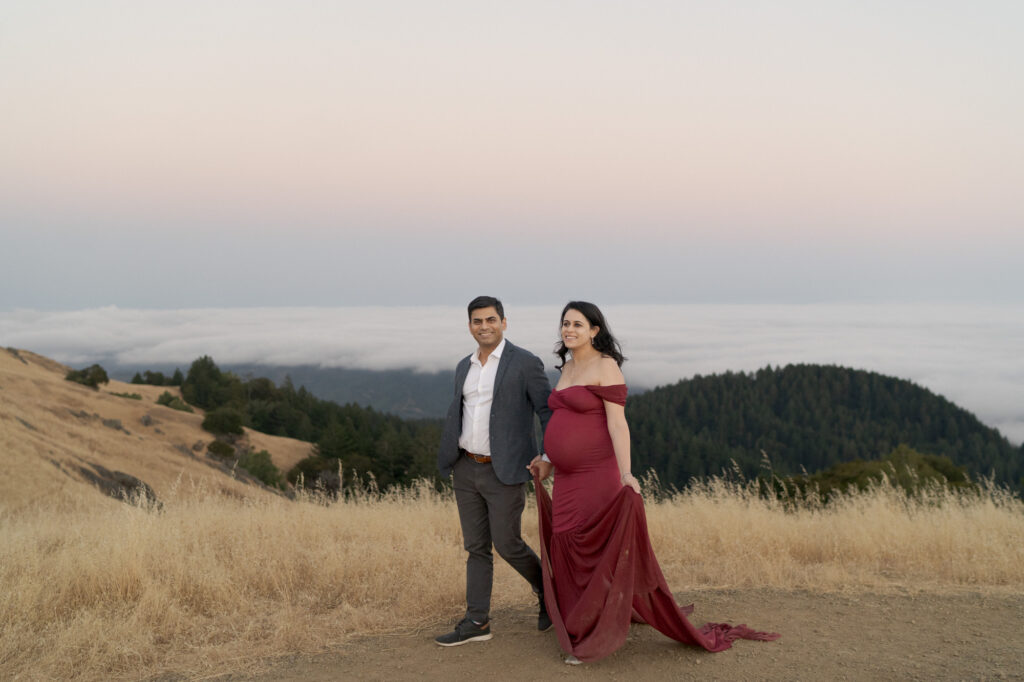 Indian-american parents-to-be hold hands and walk together.