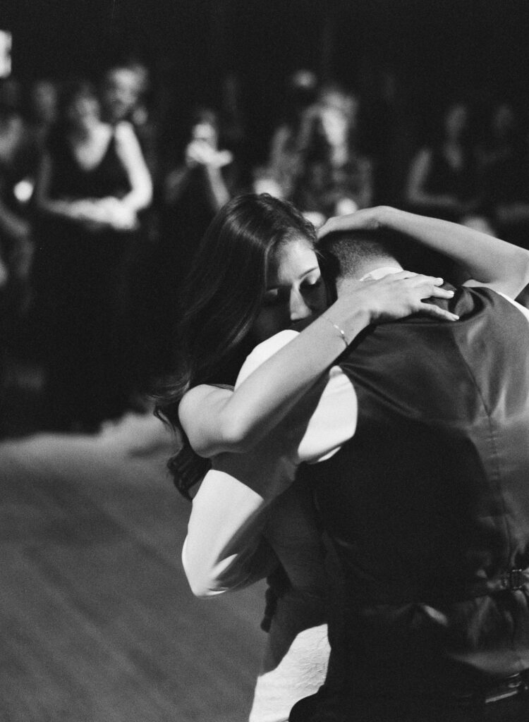 Newly-wed couple hug affectionately.