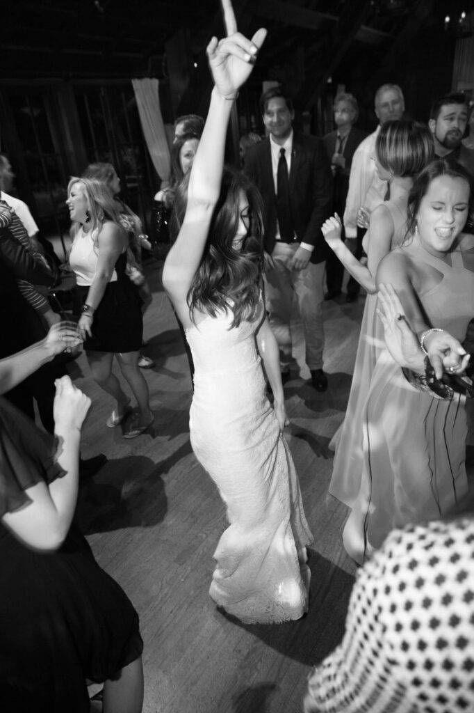 Newlywed bride hits the dance floor amidst other afterparty guests.