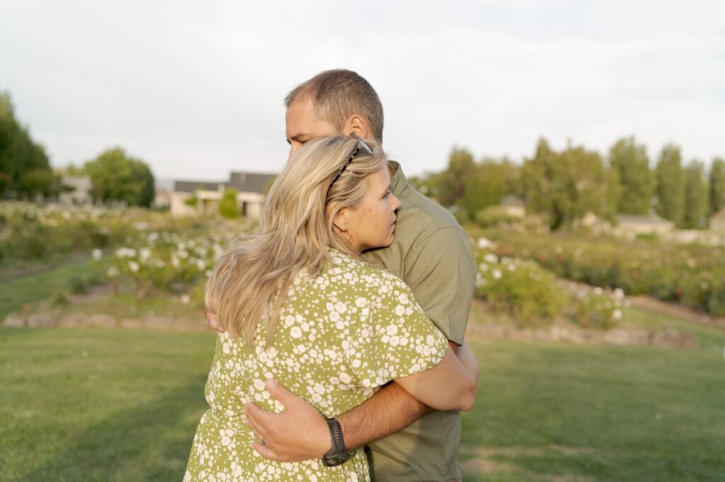 Wedding guests and couple hug each other and enjoy the tender moment at Garden Valley Ranch.