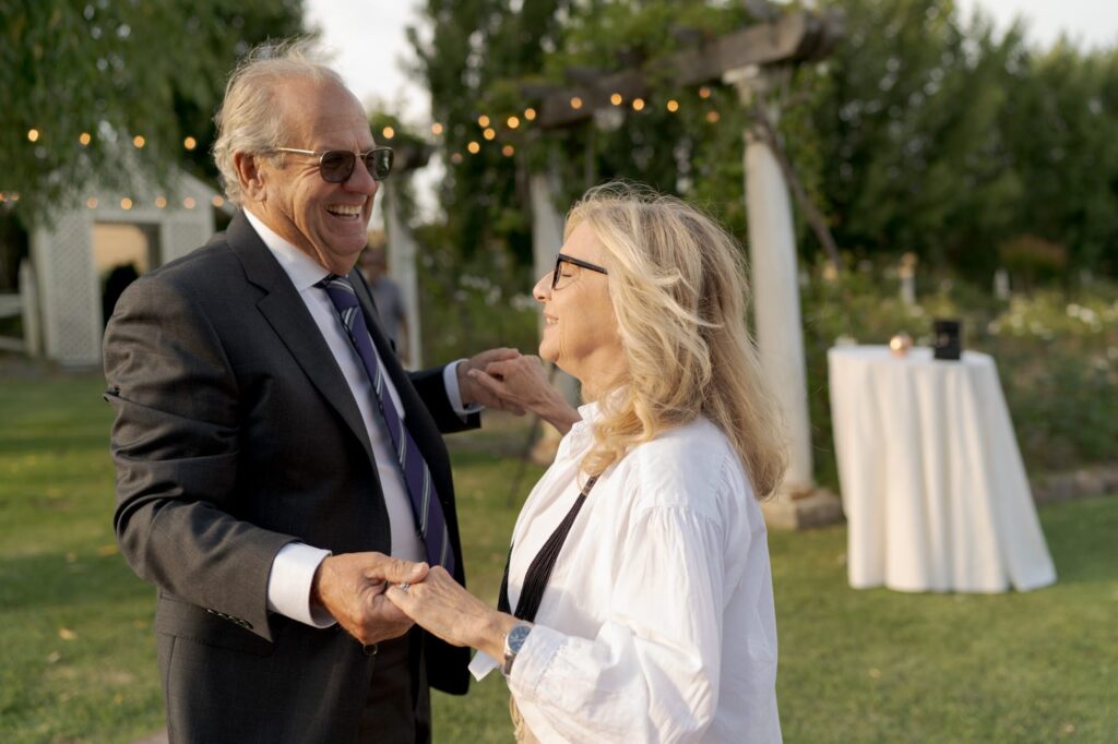 Elderly wedding guests and couple dancing at the wedding reception.