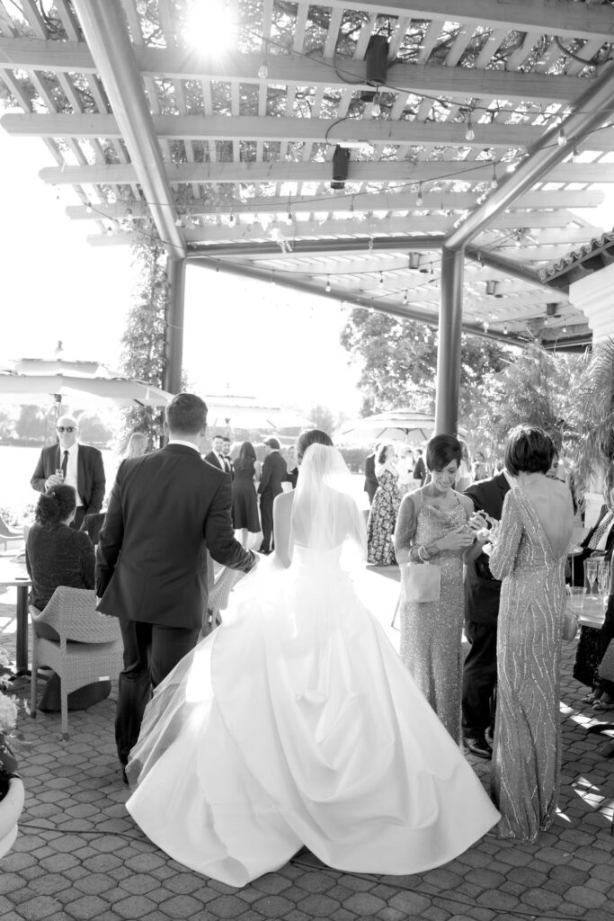 Bride and groom walk into the cocktail hour.