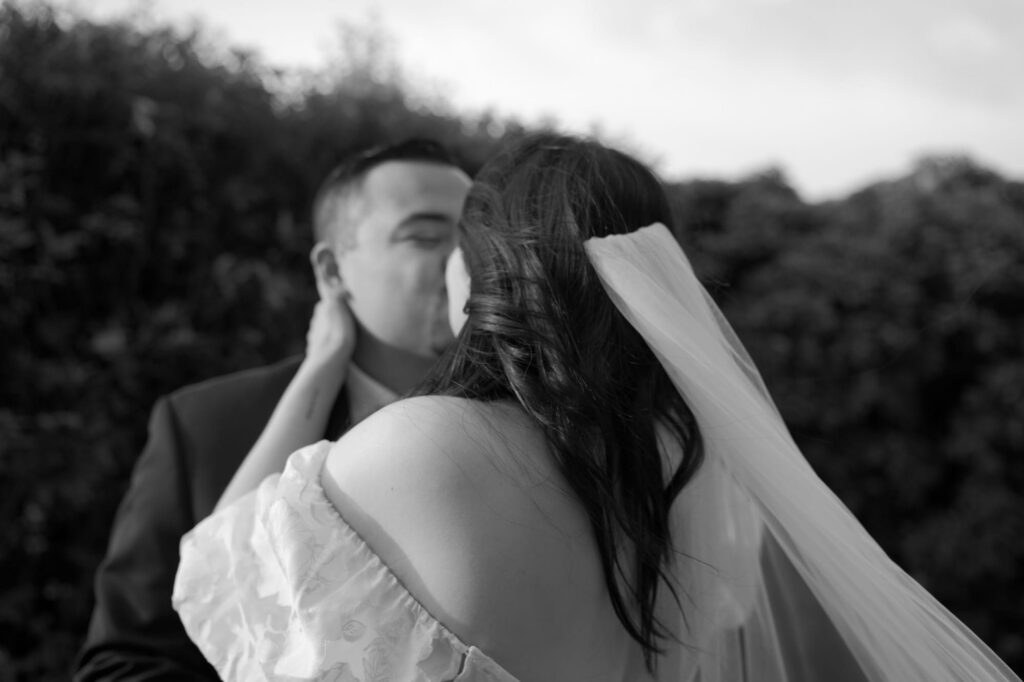 Newly pronounced husband and wife kiss each other on the lips.