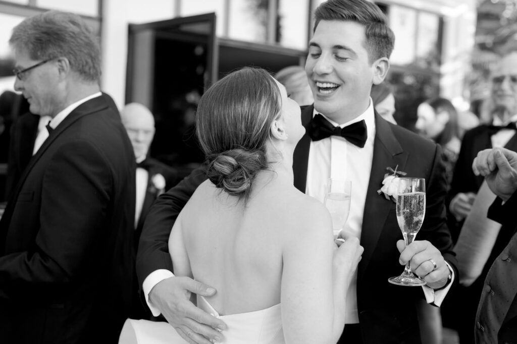 Bride and groom hold bubbly champagne and get close with each other.