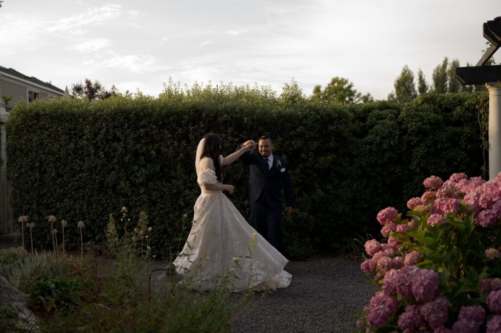 Groom lifts the bride's hand and spins her for a twirl.