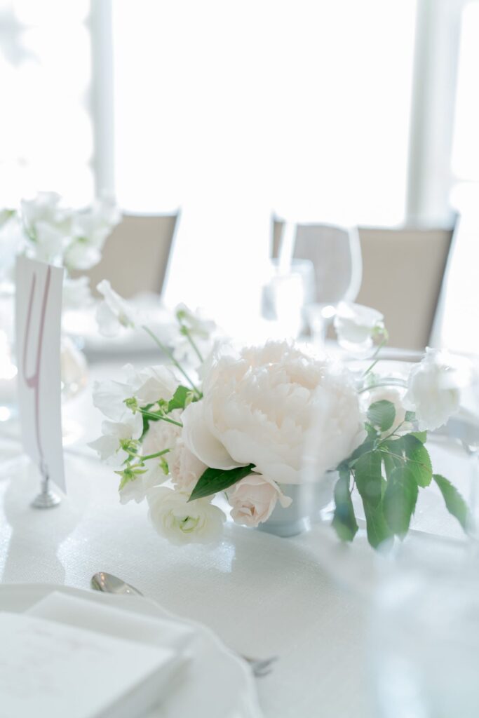 Table and cutlery decoration in a white floral theme.