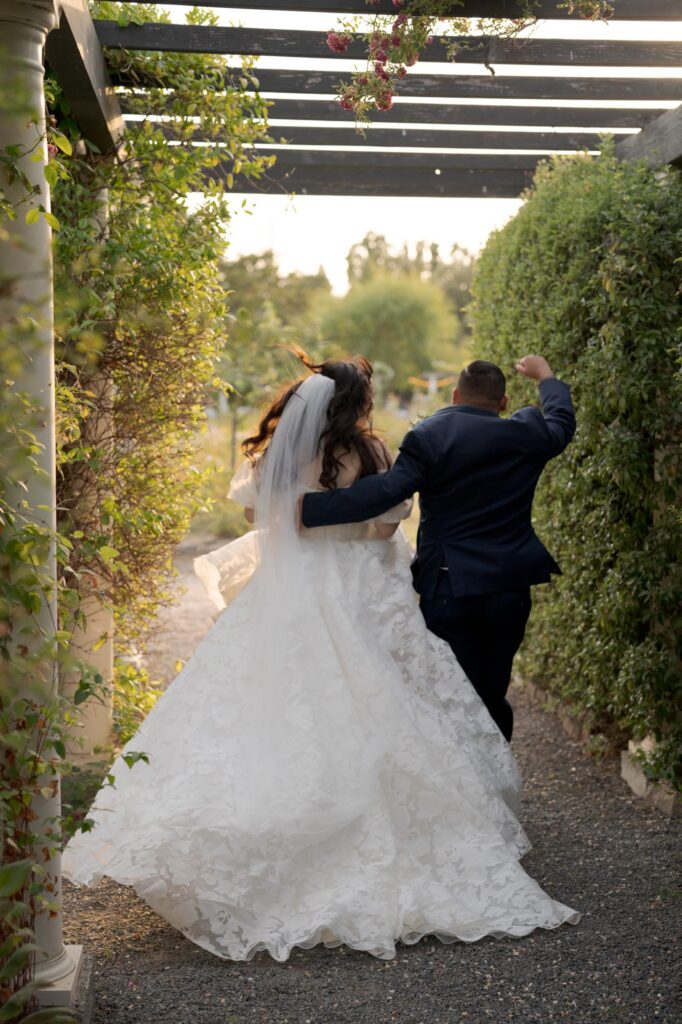 Groom grabs the bride by her waist and leads her to a new life.