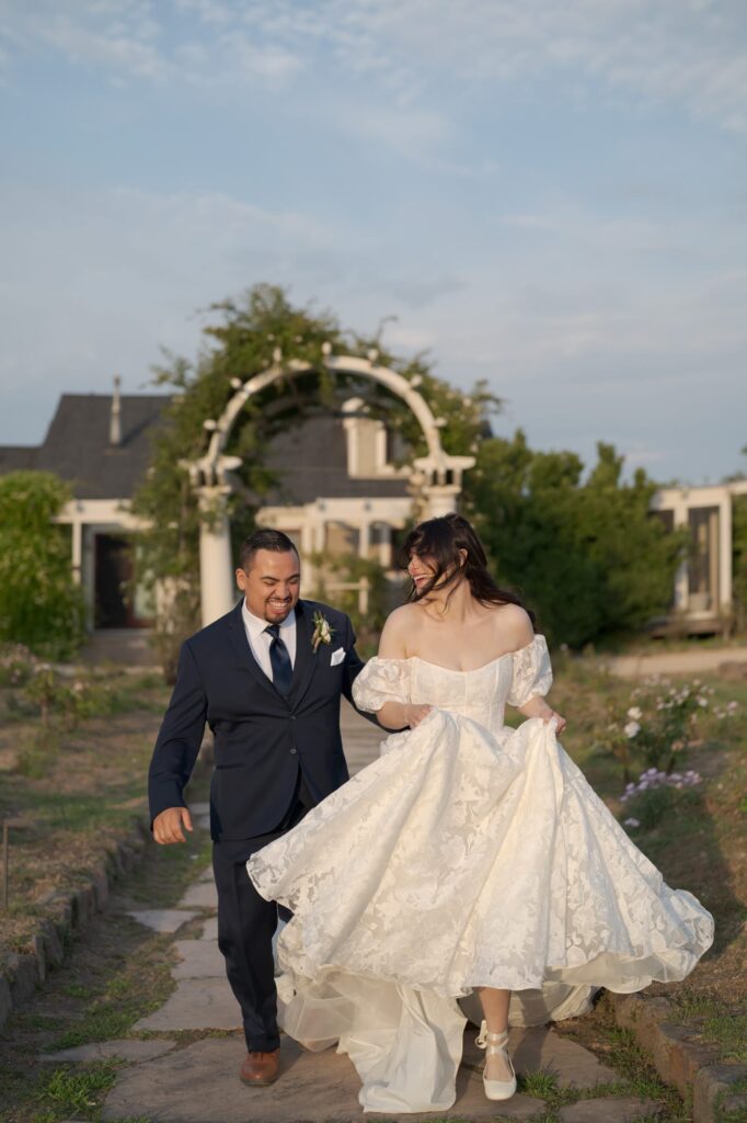 Happy bride and groom imitate running away towards a new life of companionship.